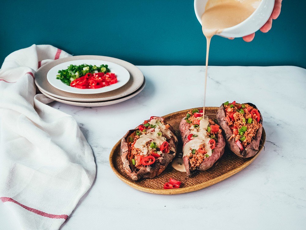 Baked sweet potatoes with Eat me at and tahini sauce